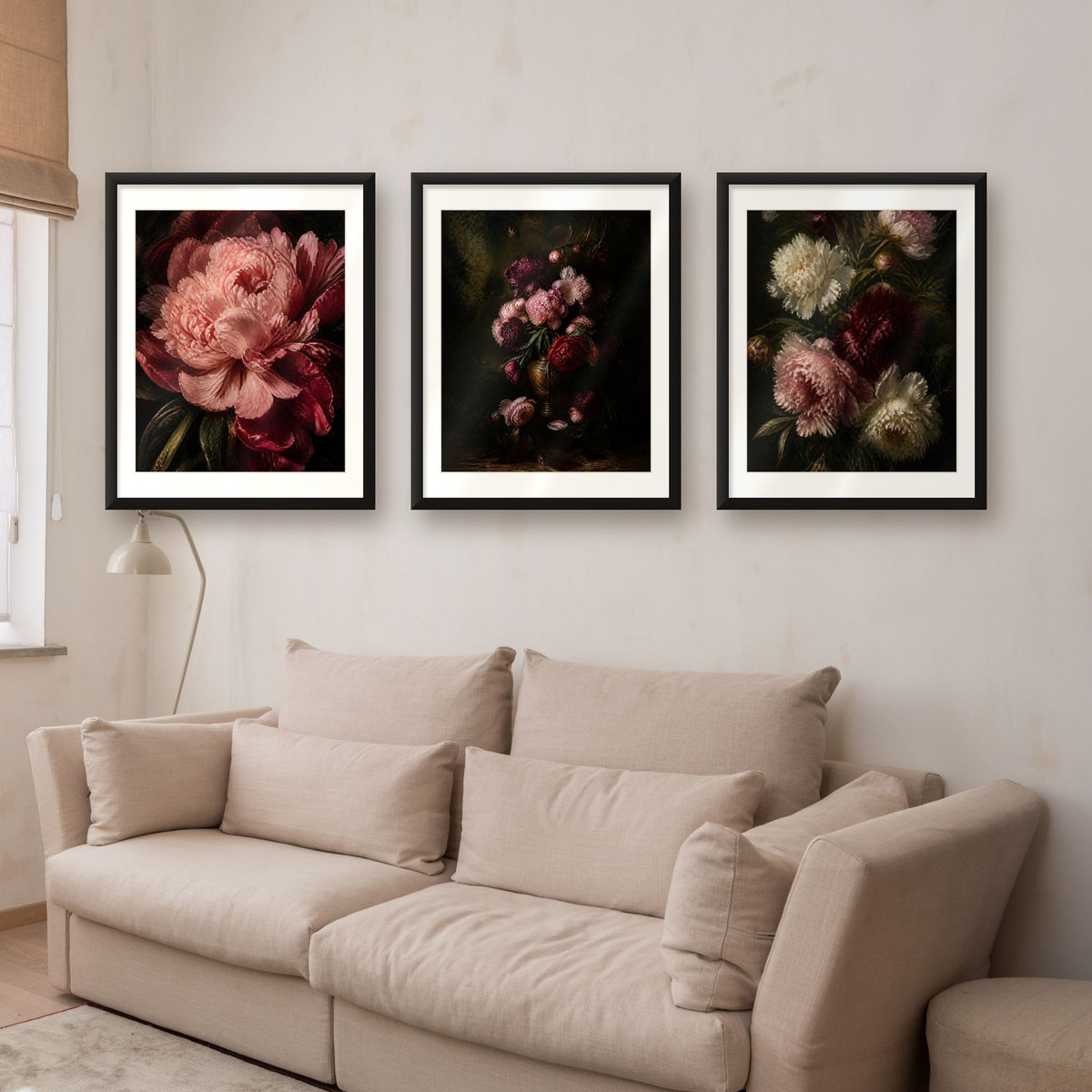 Dark moody peony wall art set of 3 in black frames above a beige sofa