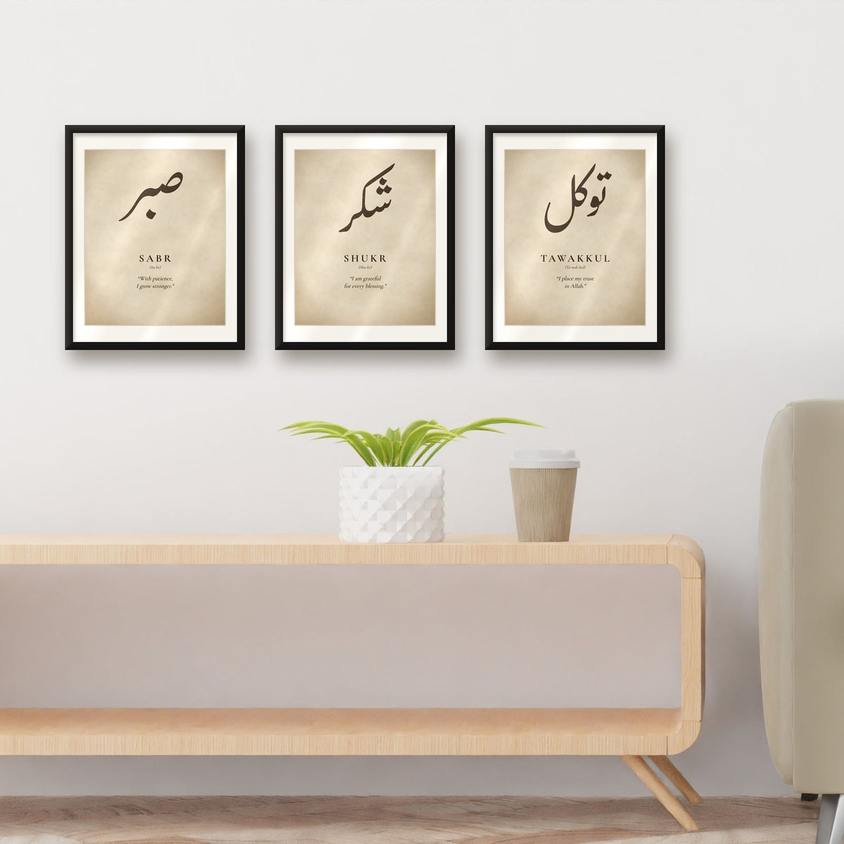 Set of 3 Arabic calligraphy prints in black frames above a wooden sideboard